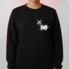 Woman wearing a black Cute Cartoon Cow Sweatshirt with a cute cartoon cow printed on the chest.