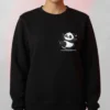 Model wearing a black Dancing Panda Cartoon Sweatshirt with a small graphic on the front.